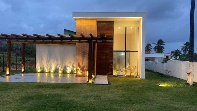 The house at dusk with the pergola lit