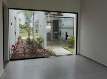 Living area opening onto the garden through full-height glass