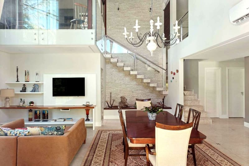 Double-height living and dining rooms with the staircase