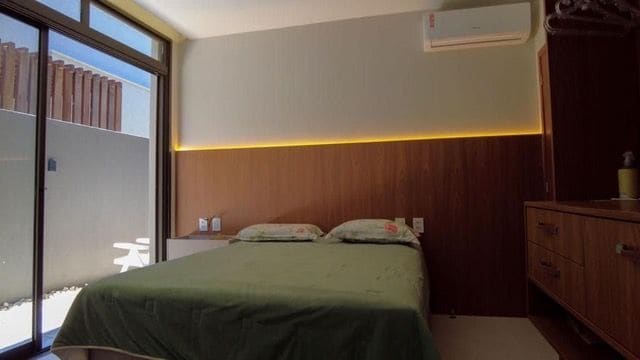 En-suite bedroom with wood paneling