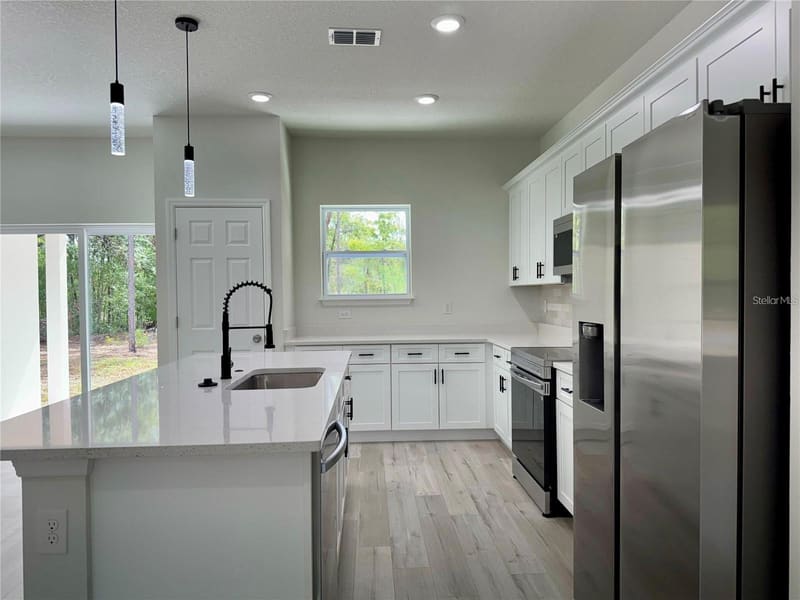 Kitchen with refrigerator and island