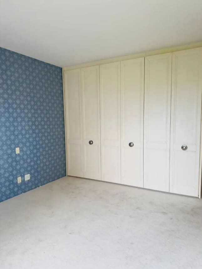 En-suite bedroom with cabinetry